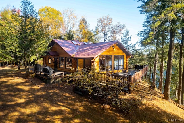 back of property featuring a wooden deck