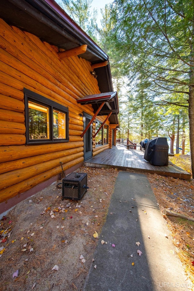 view of property exterior featuring central AC and a wooden deck