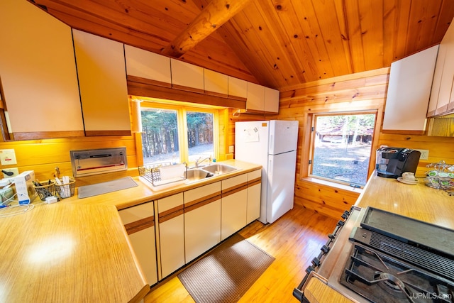 kitchen featuring wooden ceiling, light wood-type flooring, vaulted ceiling with beams, range, and white refrigerator