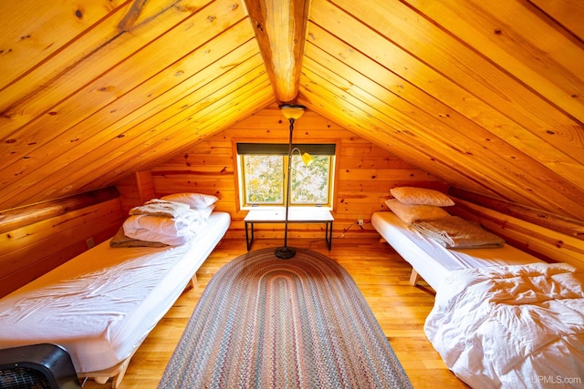 bedroom with wood ceiling, wood walls, lofted ceiling with beams, and light wood-type flooring