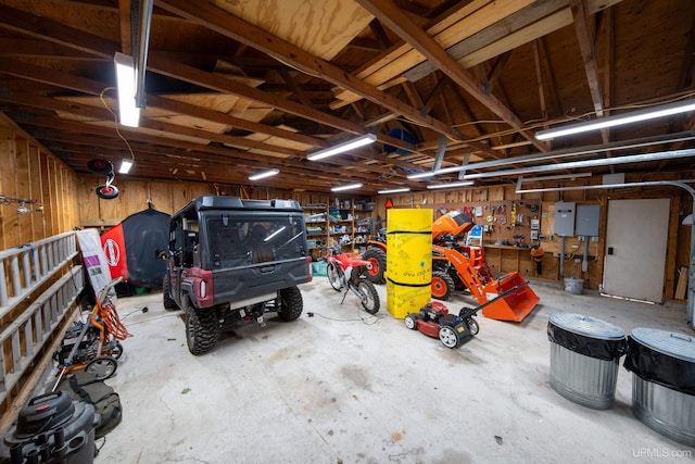 garage with wood walls and a workshop area