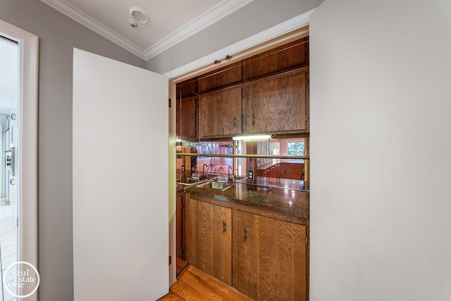 hallway with ornamental molding and a sink