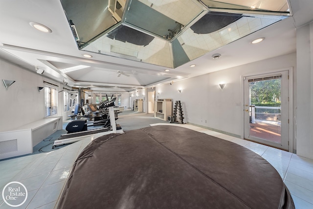 gym featuring a ceiling fan, tile patterned flooring, and recessed lighting