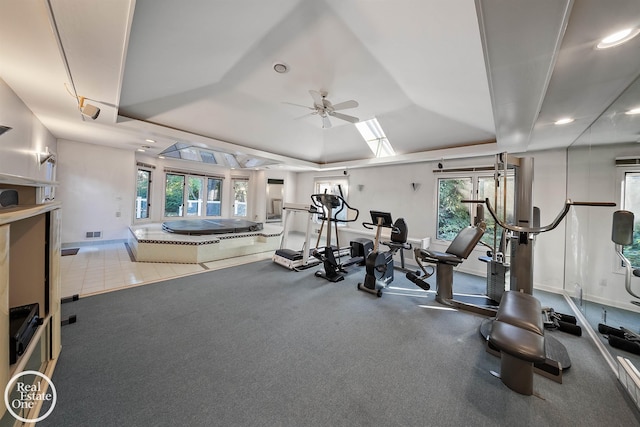 exercise room with visible vents, a tray ceiling, recessed lighting, and ceiling fan