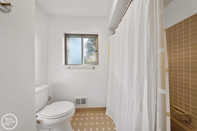 bathroom featuring tile patterned floors, visible vents, a shower with shower curtain, and toilet