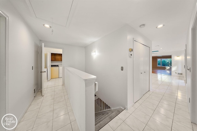 hallway with attic access, washer and clothes dryer, recessed lighting, an upstairs landing, and light tile patterned floors