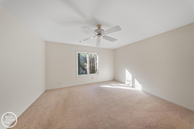 spare room with carpet floors, visible vents, baseboards, and ceiling fan