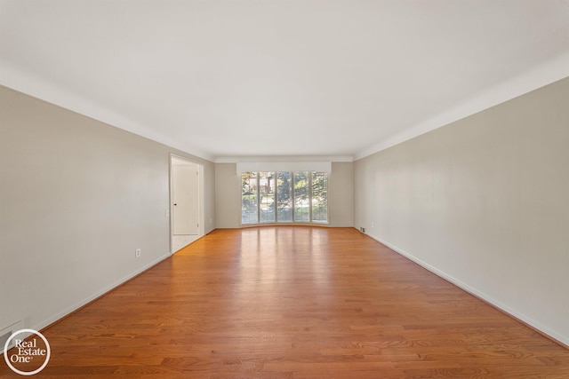 unfurnished room with light wood-style floors and baseboards