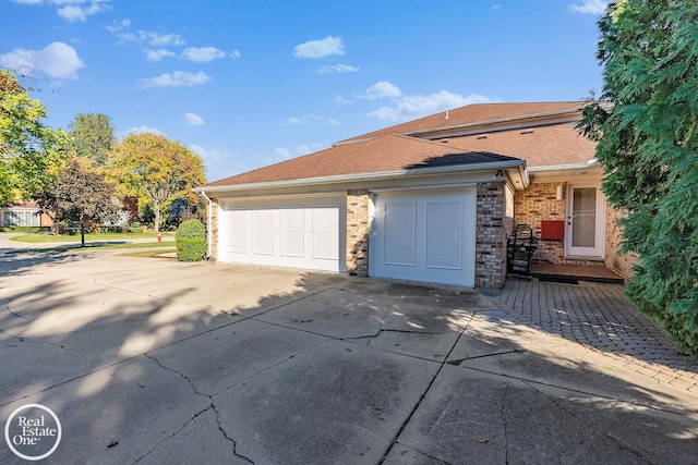 garage featuring concrete driveway