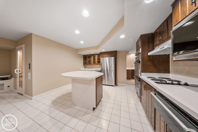 kitchen with stainless steel fridge, a kitchen island, white gas cooktop, light tile patterned flooring, and double oven