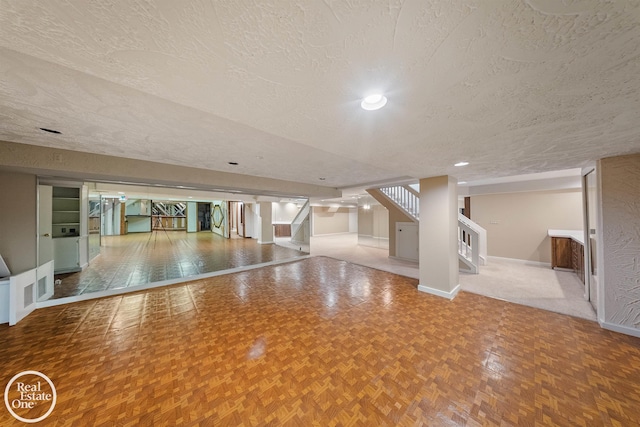 interior space featuring recessed lighting, stairway, a textured ceiling, and baseboards