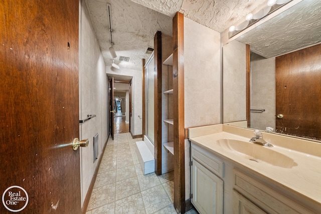 bathroom with vanity and a textured ceiling