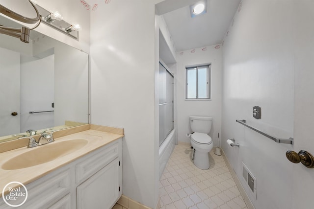 full bathroom featuring vanity, combined bath / shower with glass door, toilet, and tile patterned flooring