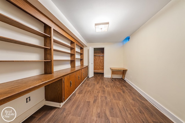 hallway with baseboards and dark wood-style flooring