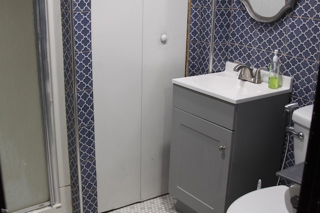 bathroom with vanity, toilet, and a shower with shower door