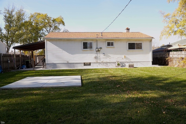 rear view of property featuring a patio and a lawn