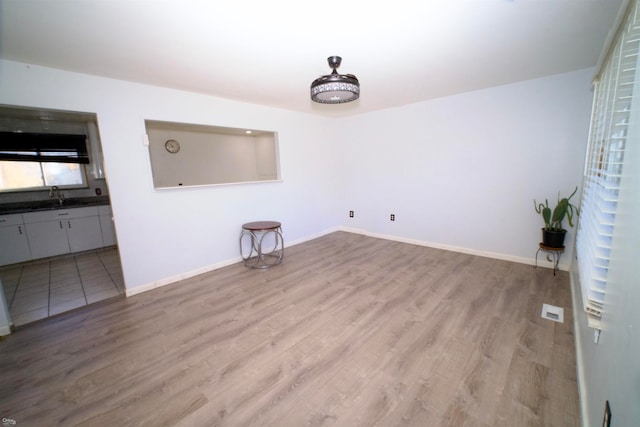 interior space with sink and light hardwood / wood-style flooring