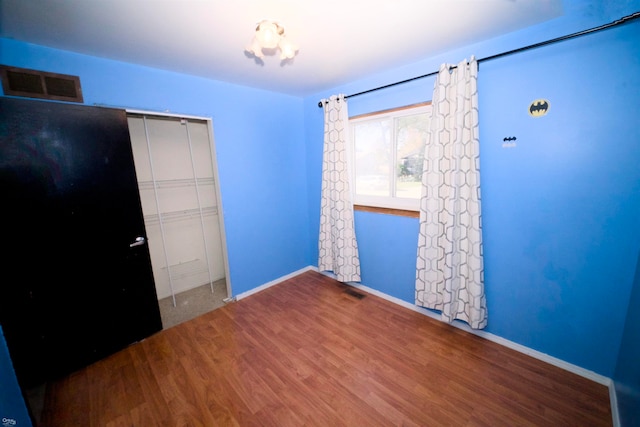 spare room with hardwood / wood-style floors