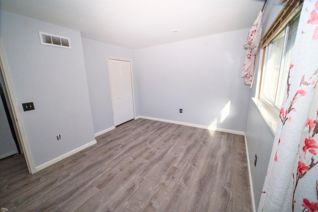 unfurnished room featuring wood-type flooring