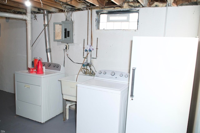 laundry area featuring sink, electric panel, and washing machine and clothes dryer