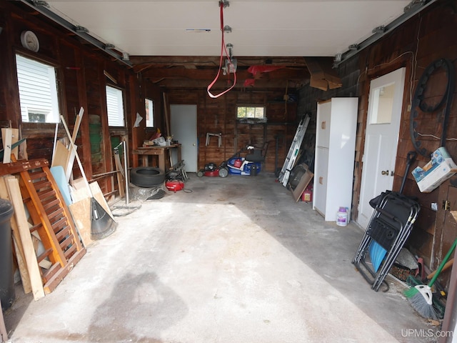 garage featuring wood walls