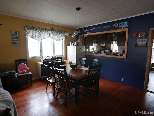 dining room featuring crown molding and hardwood / wood-style floors