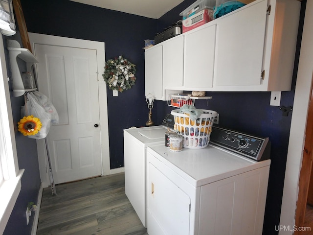 washroom with cabinets, separate washer and dryer, and hardwood / wood-style floors