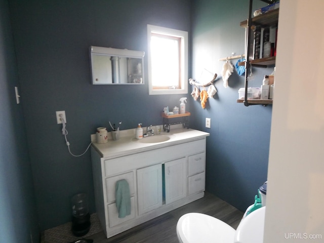 bathroom featuring vanity, toilet, and hardwood / wood-style floors