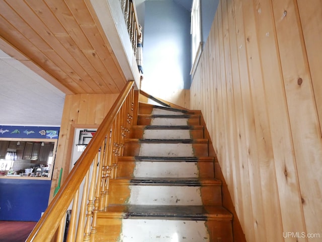 staircase with wood walls