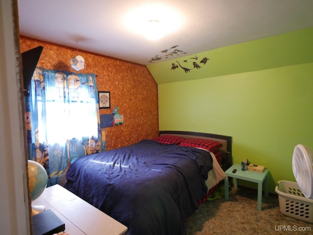 bedroom featuring vaulted ceiling and carpet floors