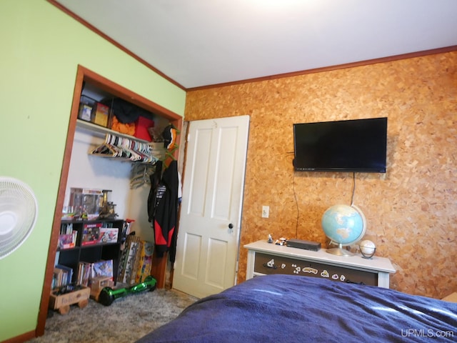 bedroom featuring a closet, crown molding, and carpet floors