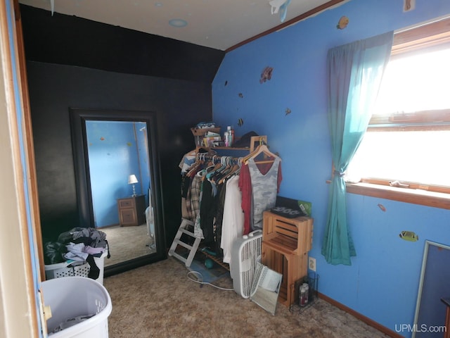 bedroom featuring lofted ceiling and carpet flooring