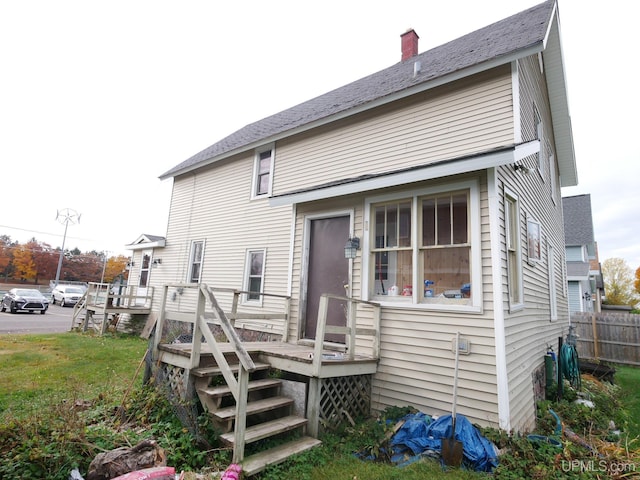 back of property featuring a deck