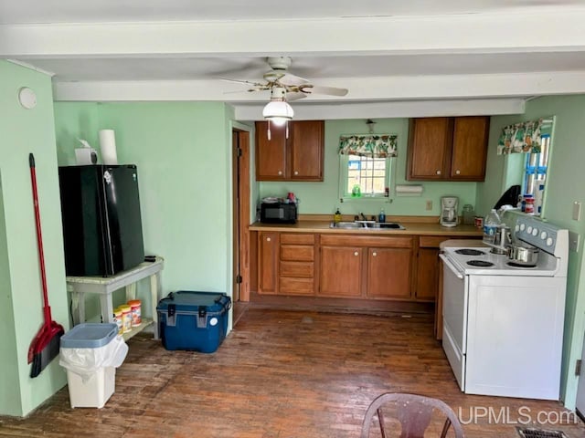 kitchen featuring black refrigerator, sink, white range with electric stovetop, dark hardwood / wood-style flooring, and ceiling fan