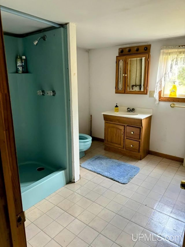 bathroom with vanity, toilet, and tile patterned flooring