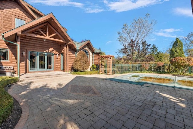 view of pool with french doors, a patio area, and a hot tub