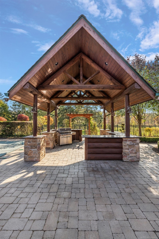 view of patio featuring a gazebo, an outdoor kitchen, and area for grilling