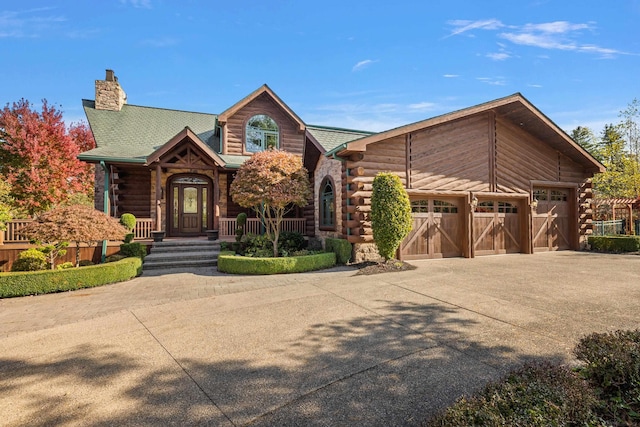 log cabin featuring a garage