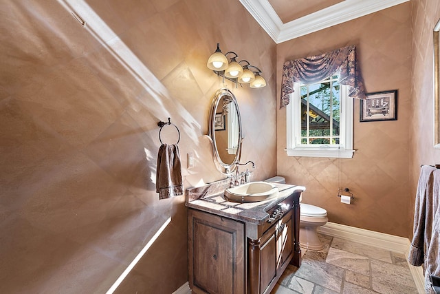 bathroom with vanity, crown molding, and toilet