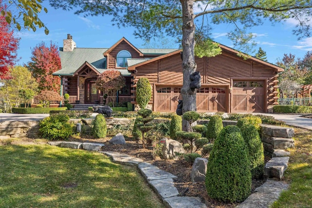 log cabin with a porch and a front yard