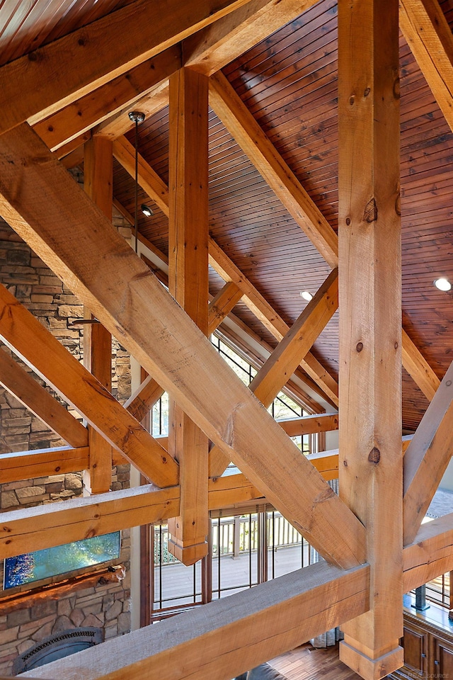 room details featuring wood ceiling, beamed ceiling, and a fireplace