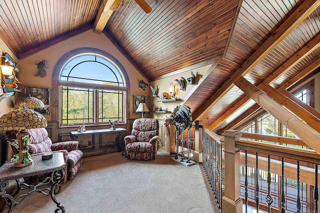 living area with wooden ceiling, lofted ceiling with beams, carpet, and plenty of natural light