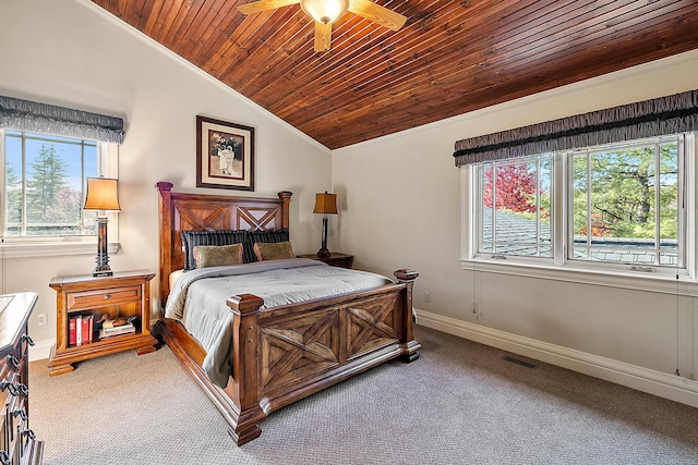 carpeted bedroom with ornamental molding, vaulted ceiling, wood ceiling, and ceiling fan