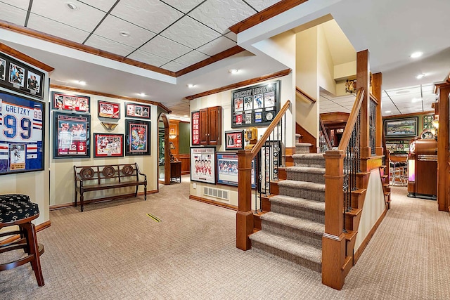 staircase featuring crown molding and carpet floors