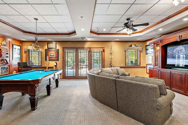 playroom with crown molding, a healthy amount of sunlight, ceiling fan, and a raised ceiling