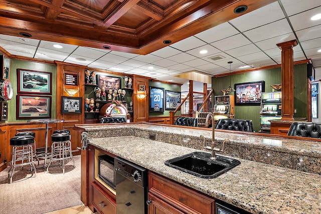 kitchen with black appliances, light stone countertops, crown molding, and coffered ceiling