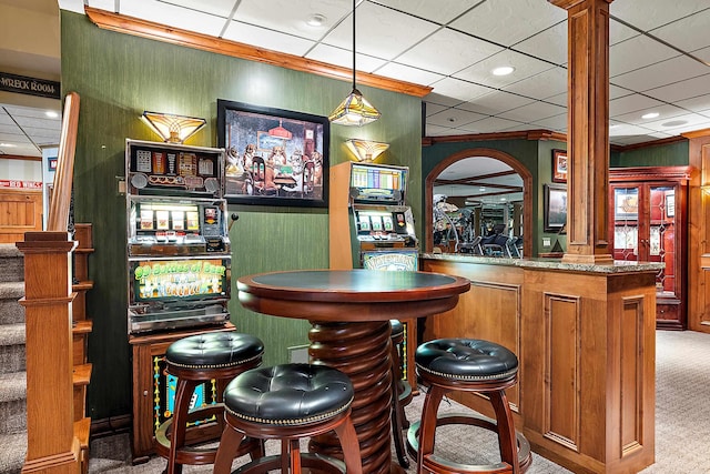 bar featuring pendant lighting, carpet, and a paneled ceiling