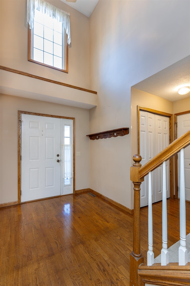 entrance foyer with a textured ceiling and hardwood / wood-style flooring