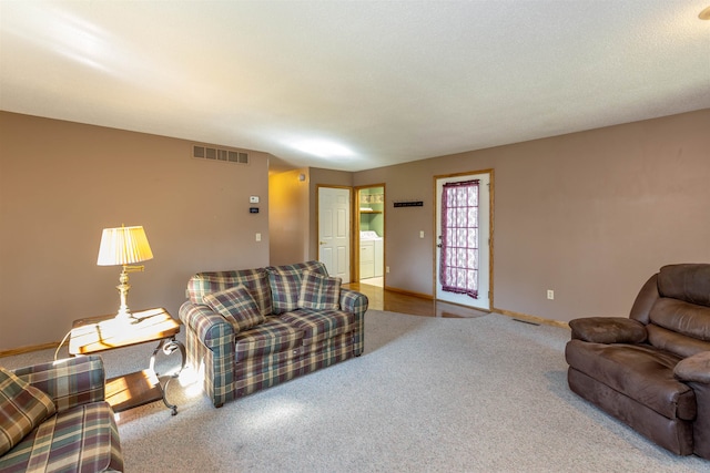 living room with carpet floors and washer and clothes dryer