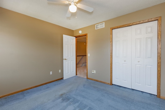 unfurnished bedroom with carpet flooring, a closet, and ceiling fan